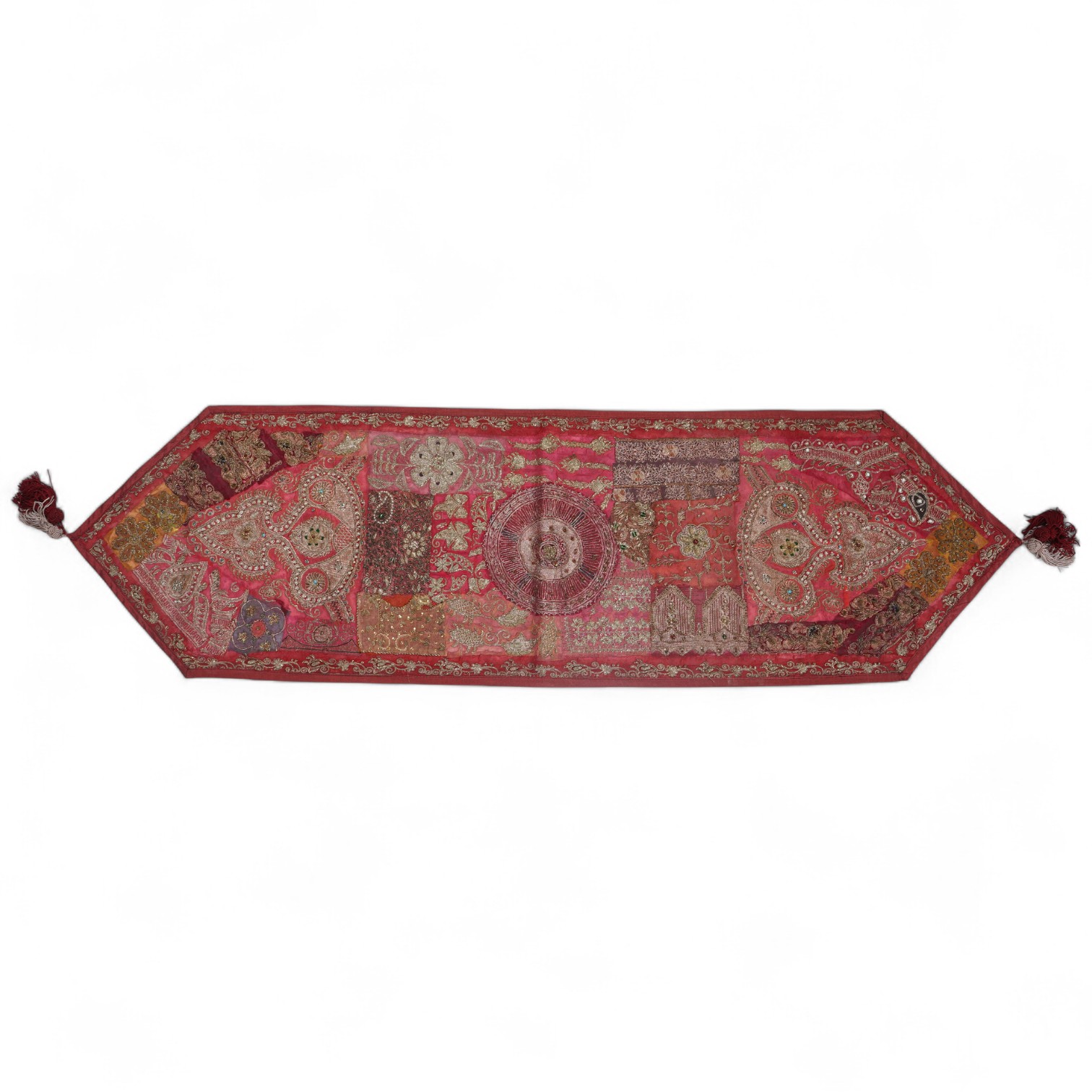 An Indian 20th century red silk marriage banner/hanging, ornately embroidered in silver and gold thread, with raised stump work flowers, corded and designed using simulated pearls and coloured beads etc., 74cm x 43cm. Co